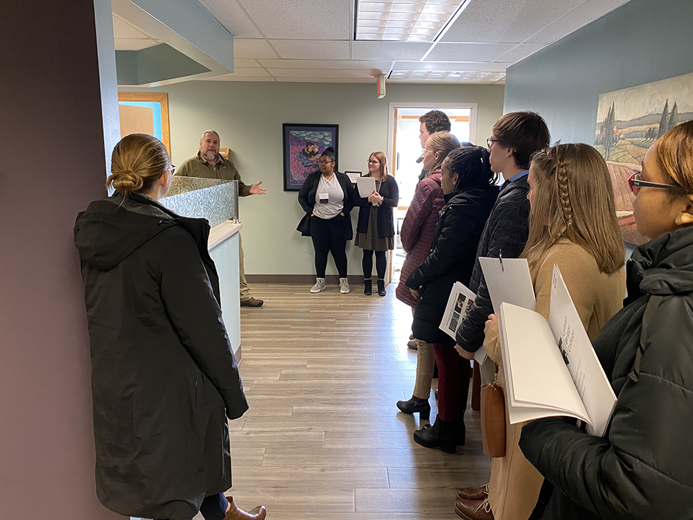 Dr. Jeffrey VanWingen talks to a group of students within his medical office