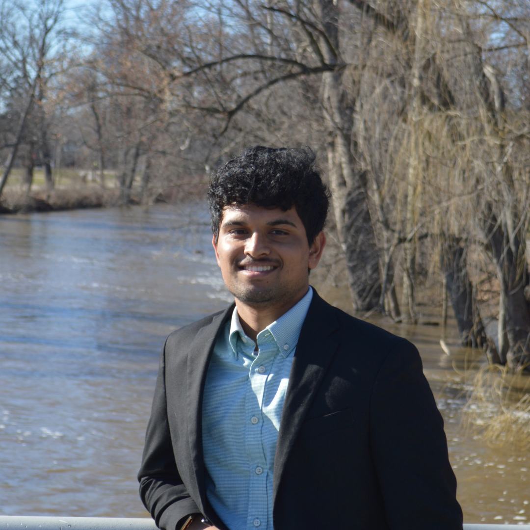 Picture of Varun Varre standing in front of a river.